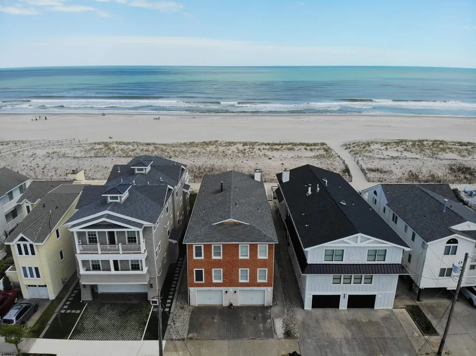 We see the Ocean City, NJ shore in front of a row of houses.