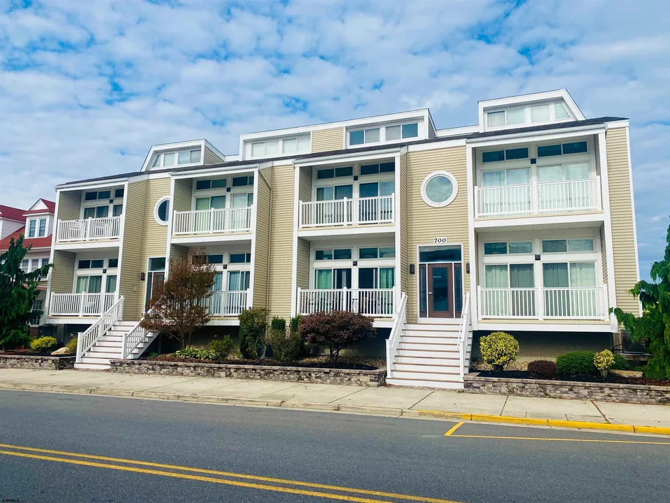 A beige condominium in Ocean City, NJ against a clear blue sky.