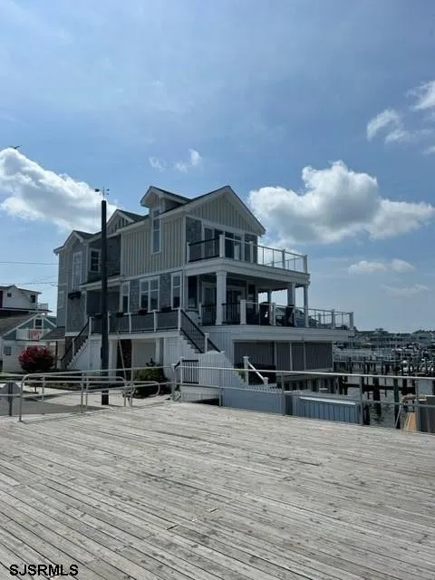 We see the front of a large home on the water in Ocean City, NJ.