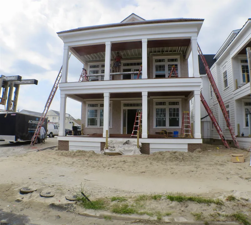 We see the front of a new-construction, white and beige house in Ocean City, NJ.